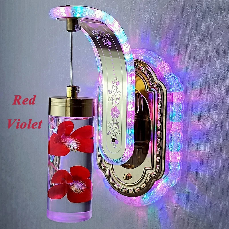 Decorative wall hook with LED lights and a bottle of red liquid with flowers on a gray background.