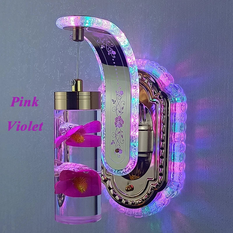 Decorative wall light with pink and violet flowers and LED lighting on a gray background.
