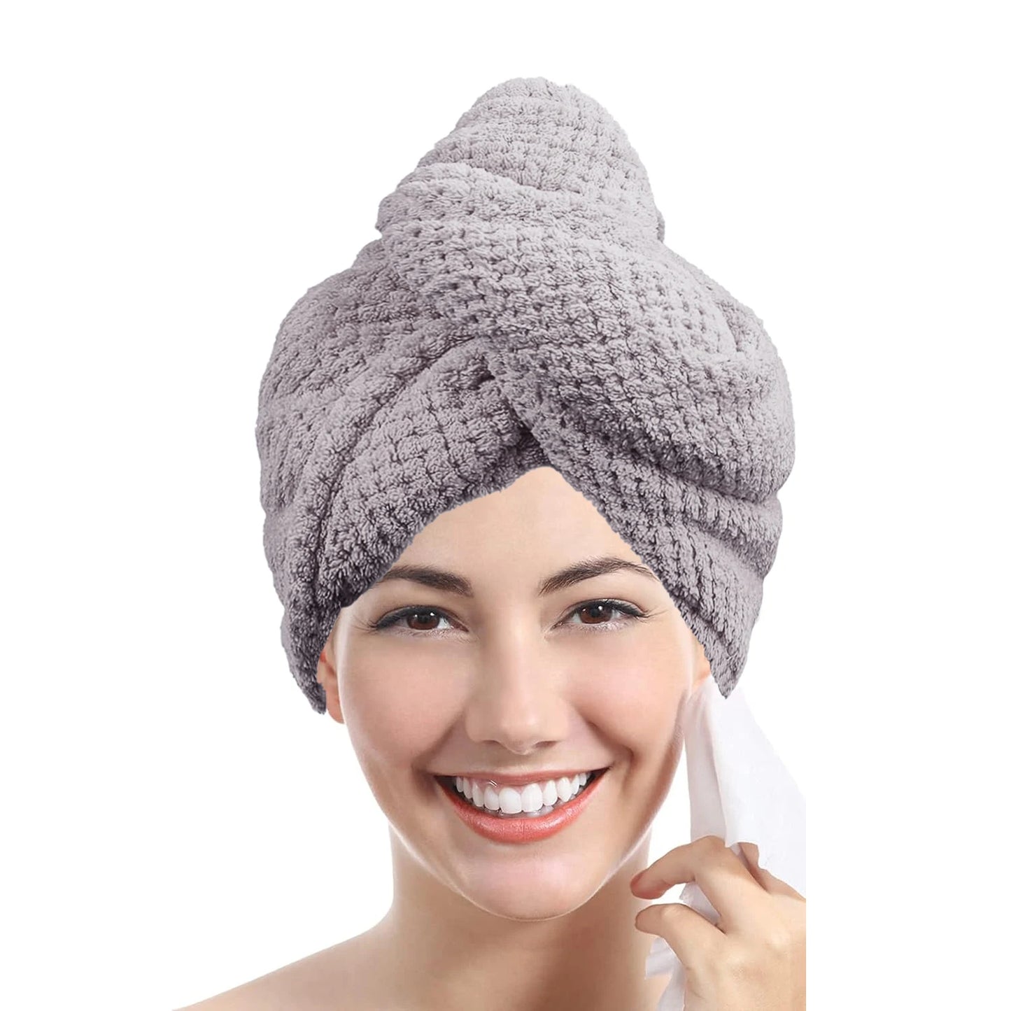 Woman wearing a gray towel turban on a white background