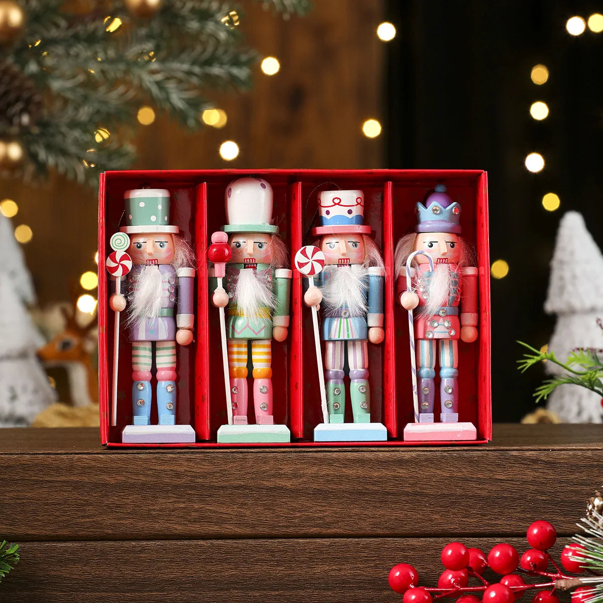 Four colorful nutcrackers in a red box with Christmas decorations in the background