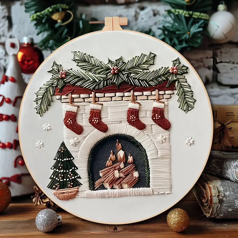 Embroidery hoop with a Christmas-themed design featuring stockings, a fireplace, and trees.