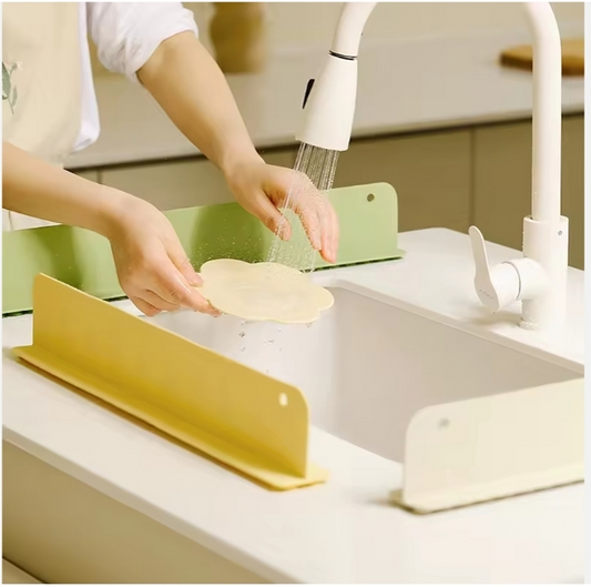 Person washing a tortilla in a kitchen sink with a yellow dish rack.