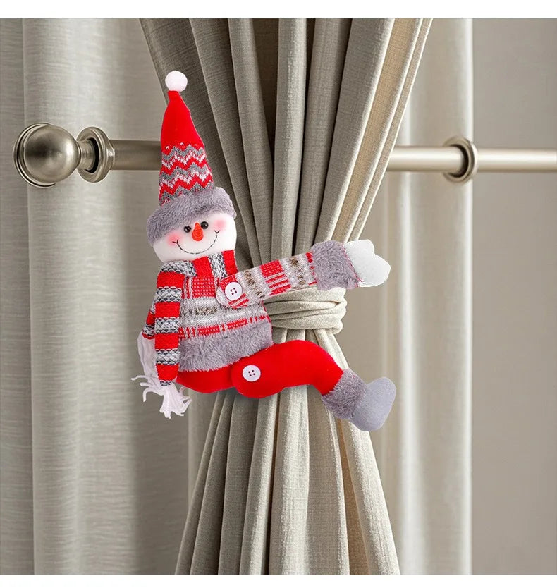 Decorative snowman curtain tieback with a striped scarf and red hat on a beige curtain.