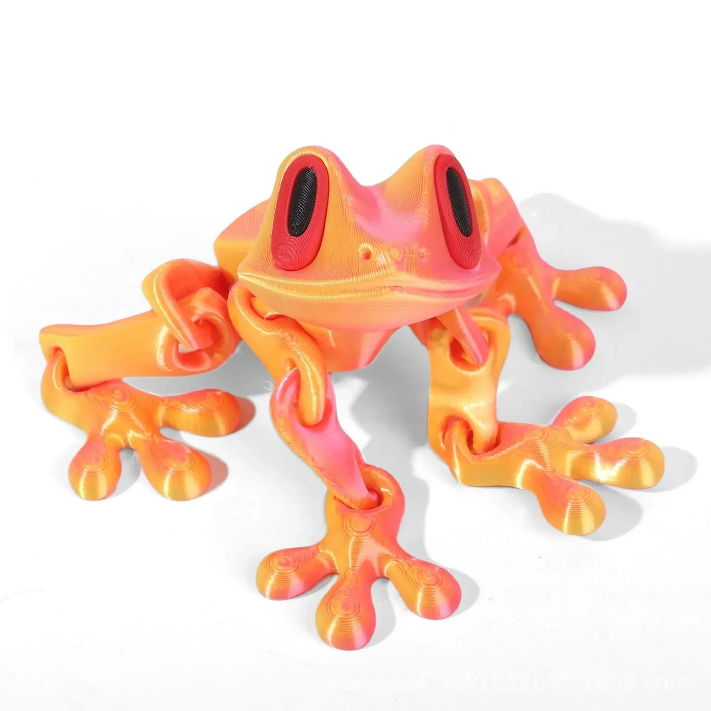 Colorful frog-shaped toy on a white background