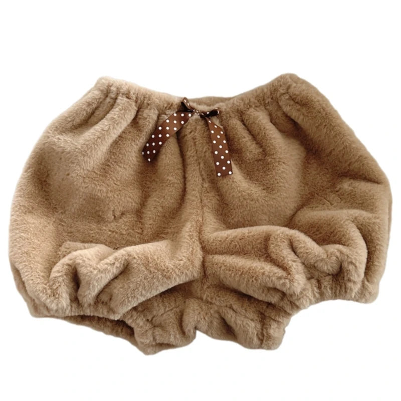 Beige fluffy bloomers with a brown polka dot ribbon on a white background