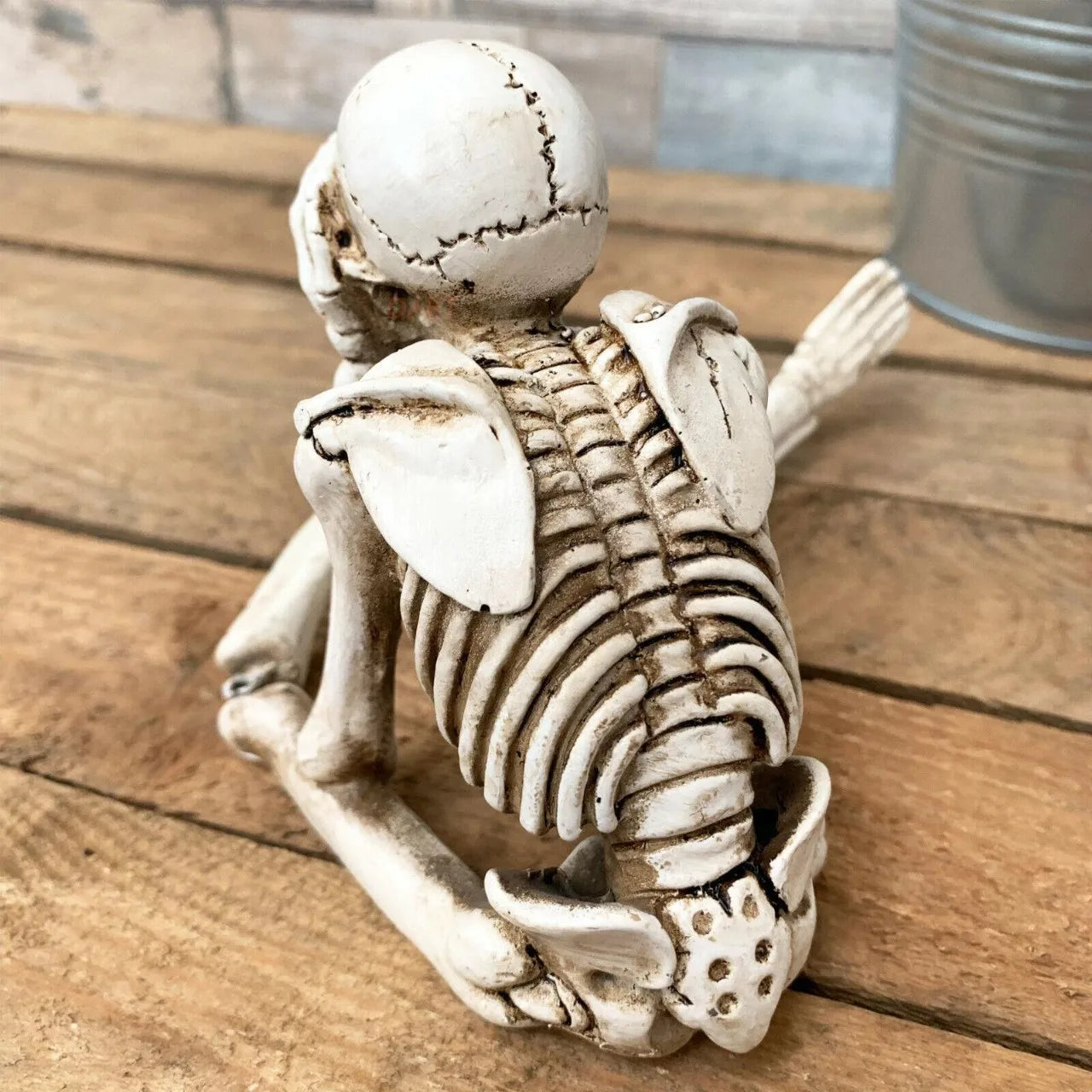 Skeletal monkey figurine on a wooden surface