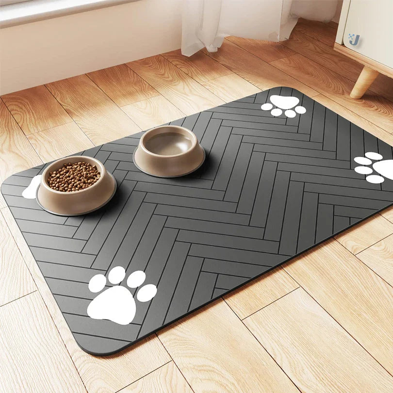 Gray pet mat with paw prints on a wooden floor with two bowls of food.