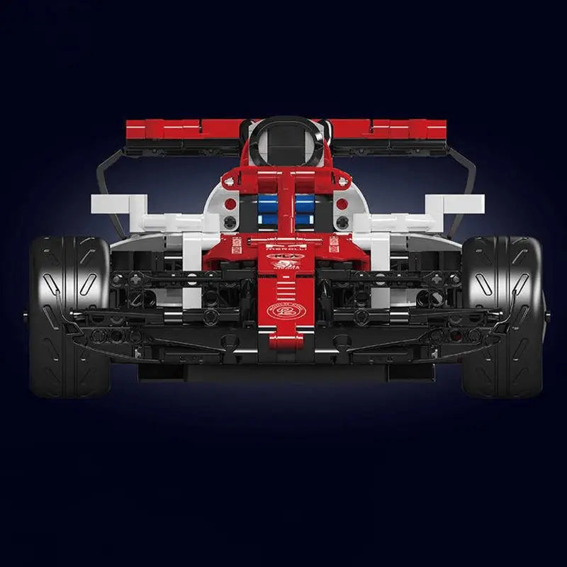 Red and white toy Formula 1 car model on a dark background