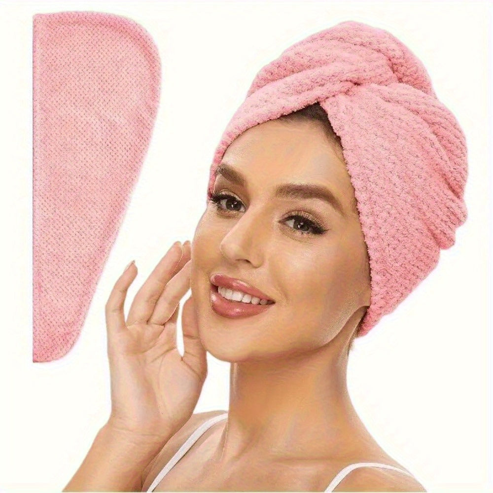 Woman wearing a pink hair towel with a matching pink product on a white background