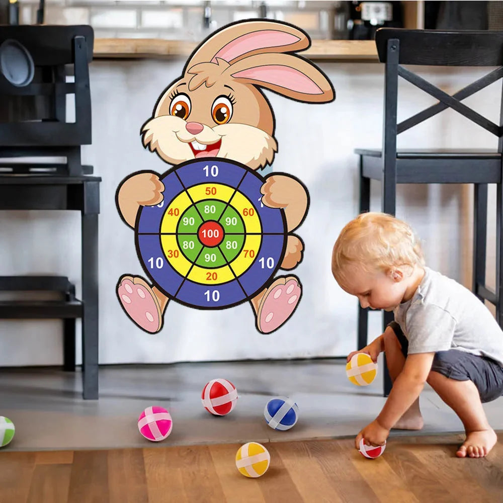 Child playing with a dartboard toy shaped like a rabbit in a kitchen.